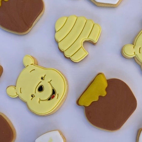 winnie the pooh, honey pot and bee hive cookies decorated by @_cookiesbycourtney